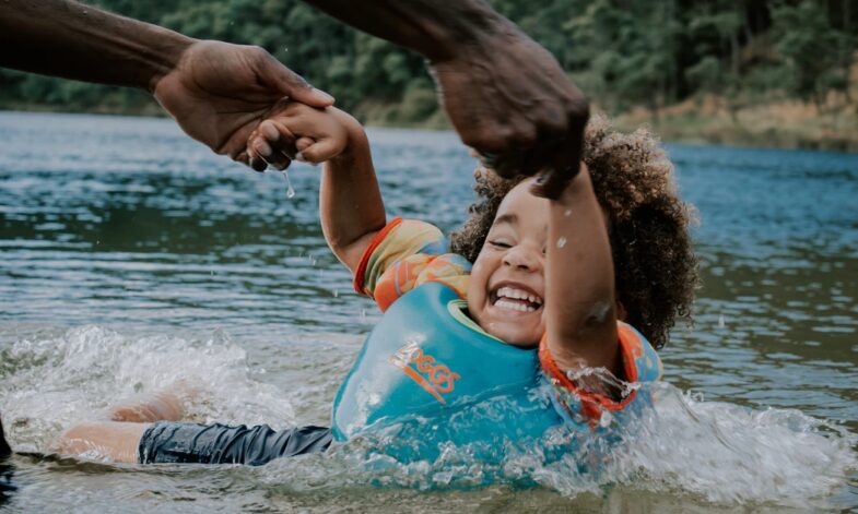 Cover Photo Child In Water With Parent 785x471